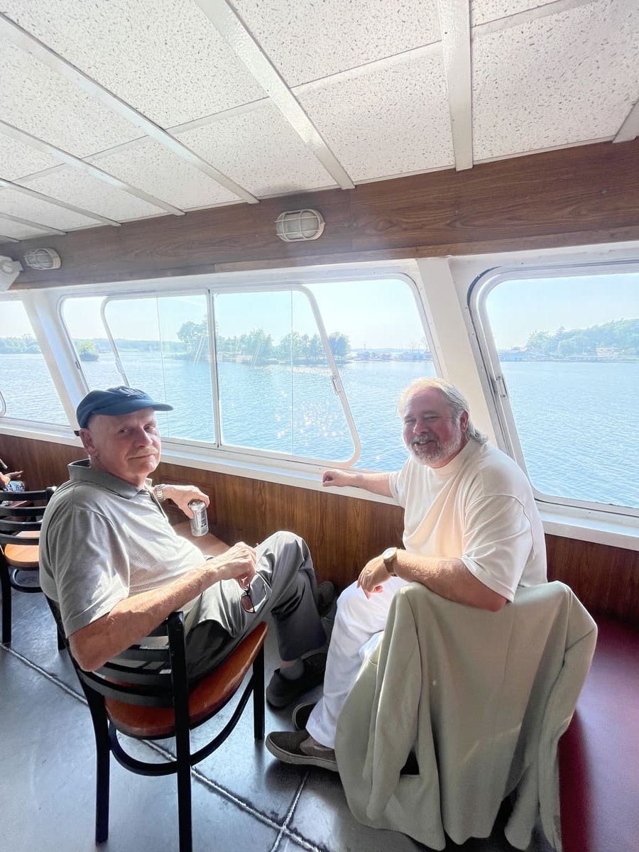 2 men looking out boat window